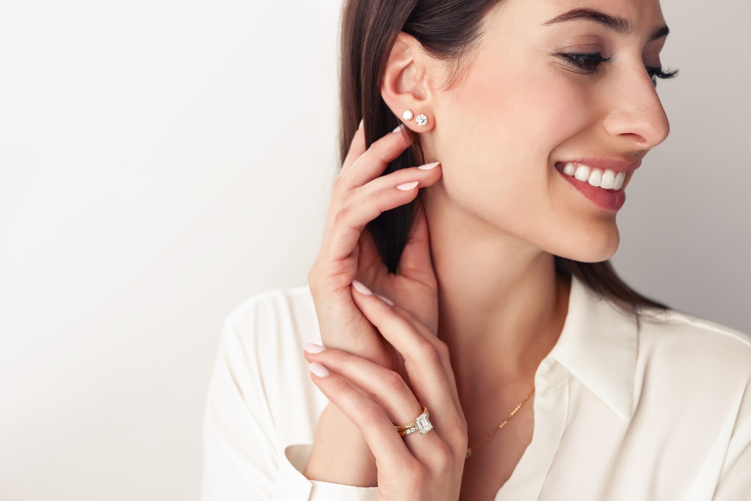 Diamond stud earring stack styled on female model