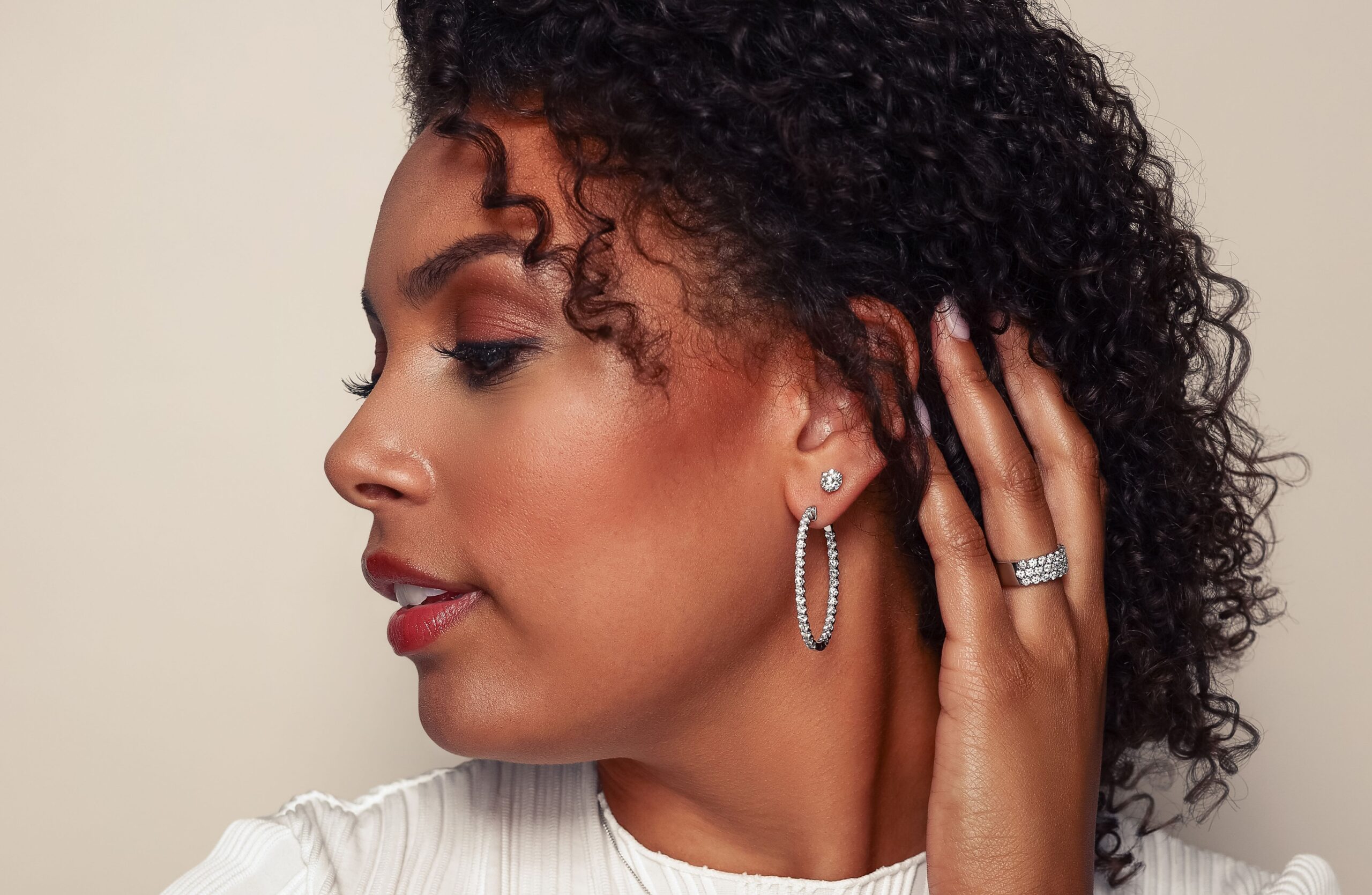 Diamond stud on hoop earring stack on female model