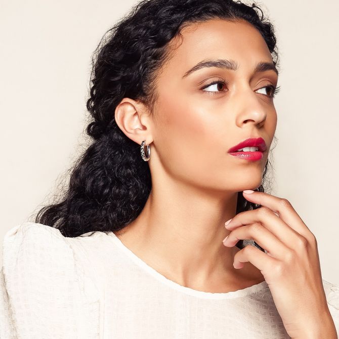 Sterling silver earrings worn by a female model