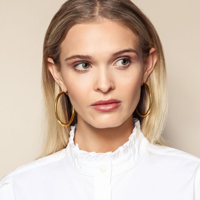 Tube hoop earrings on a model