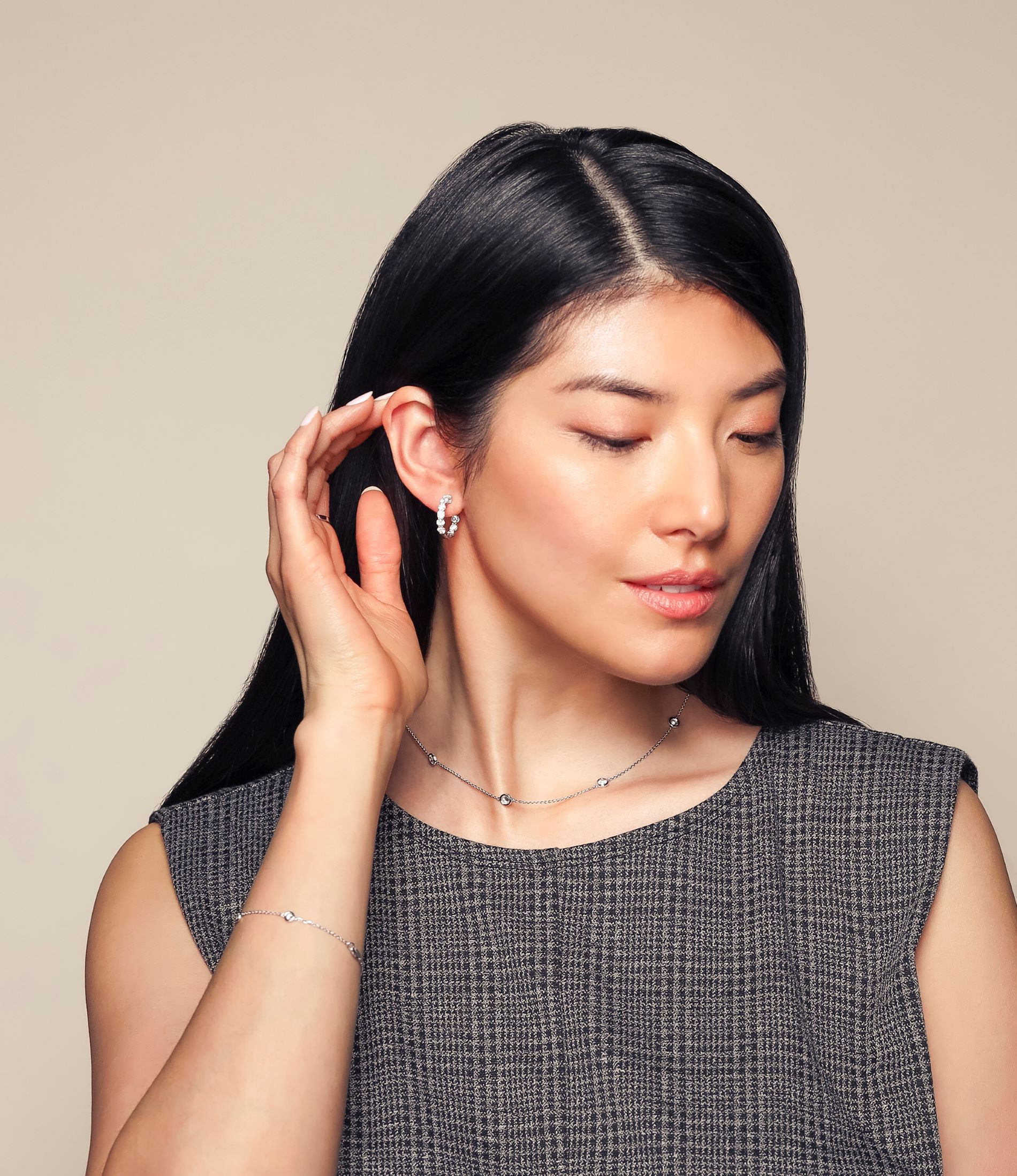 Young female model posing with small hoop earrings